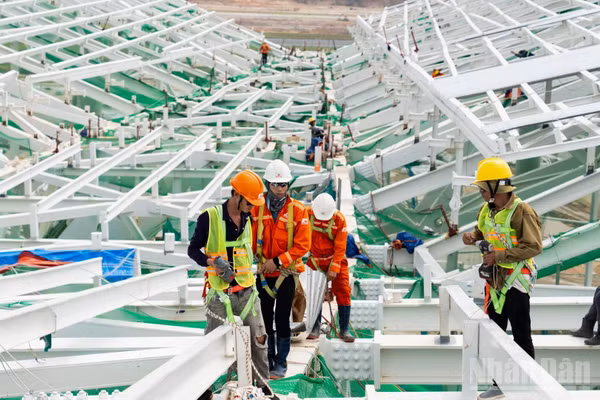 Các tổ đội đồng loạt lắp đặt hệ kính mặt dựng, tạo diện mạo hiện đại cho Nhà ga T2. (Ảnh: NA DƯƠNG)