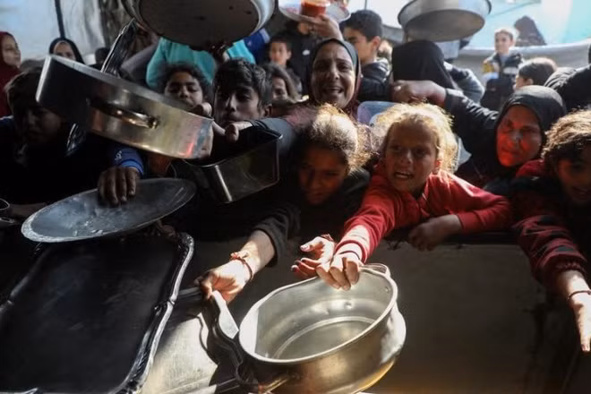 Người dân Palestine nhận thức ăn miễn phí tại một trại dành cho người tị nạn ở Beit Lahia, phía bắc Dải Gaza, ảnh chụp ngày 15/3/2026. (Ảnh: XINHUA)