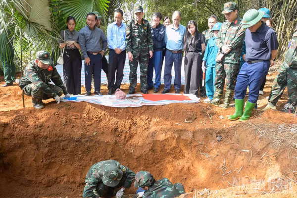Lực lượng chức năng cất bốc hài cốt liệt sĩ tại khu vực đồi Đá Vôi, phường Cam Đường. (Ảnh: CÔNG HẢI)