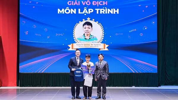 Đại diện Ban tổ chức Kỳ thi trao giải vô địch môn lập trình TOFAS 2026 tặng thí sinh Nguyễn Quang An Nguyên, Trường trung học cơ sở Lê Hồng Phong. (Ảnh: Ban tổ chức cung cấp)