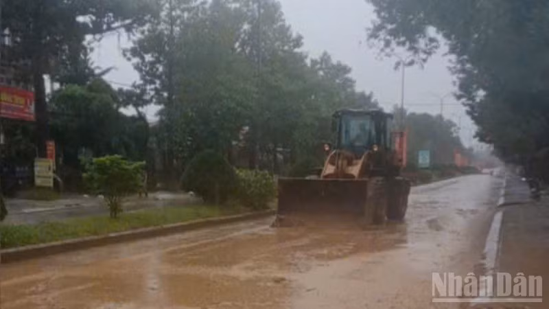 Công nhân Văn phòng Quản lý Đường bộ II.5 hót dọn bùn đất sau khi nước rút.