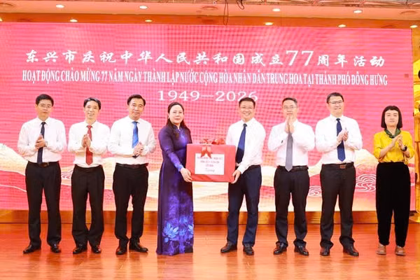 Đồng chí Nguyễn Thị Hiền, Bí thư Đảng ủy phường Móng Cái 1 chúc mừng chính quyền thành phố Đông Hưng nhân dịp kỷ niệm 77 năm Quốc khánh Trung Quốc. (Ảnh: QUANG THỌ)
