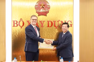 Bộ trưởng Trần Hồng Minh trao tặng Kỷ niệm chương Vì sự nghiệp Xây dựng cho Đại sứ đặc mệnh toàn quyền Cộng hòa Pháp tại Việt Nam Olivier Brochet. (Ảnh: Cổng thông tin điện tử Bộ Xây dựng)