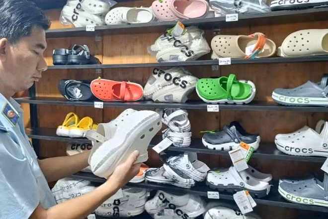 Lực lượng Quản lý thị trường Thành phố Hồ Chí Minh kiểm tra dép có dấu hiệu giả mạo nhãn hiệu tại một hộ kinh doanh.