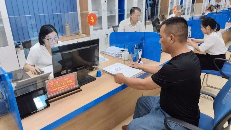 Cán bộ trung tâm phục vụ hành chính công hướng dẫn người dân thủ tục hành chính sau khi sắp xếp đơn vị hành chính theo mô hình chính quyền địa phương 2 cấp. (Ảnh: MINH PHƯƠNG)
