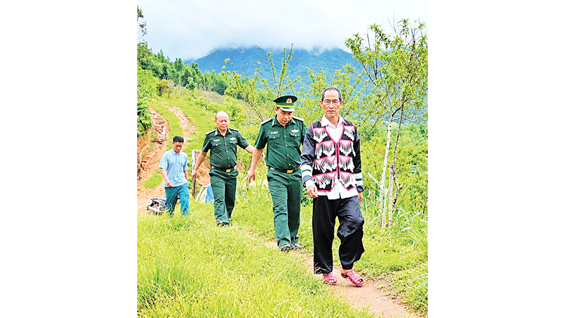Ông Thò Chứ Hờ cùng cán bộ Đồn Biên phòng Tri Lễ đến các hộ gia đình tuyên truyền về Luật Biên phòng Việt Nam.