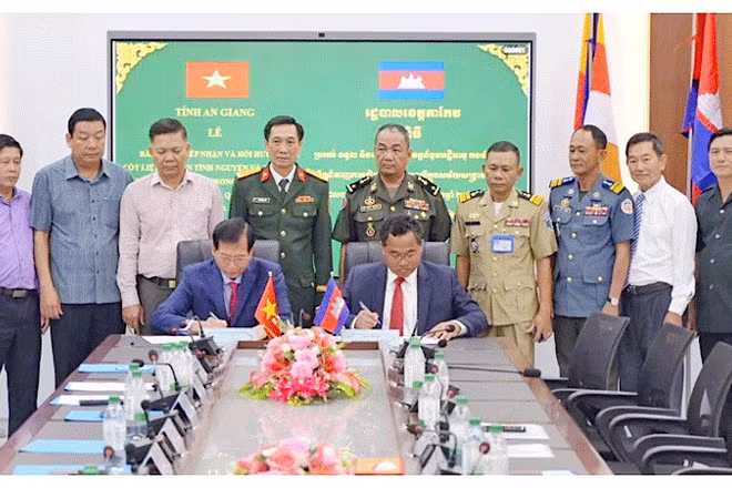 Ban chuyên trách hai tỉnh ký kết biên bản bàn giao, tiếp nhận hài cốt liệt sĩ. (Ảnh: PHƯƠNG VŨ)