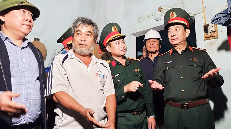 Đại tướng Phan Văn Giang (bìa phải) thăm hỏi, động viên người dân bị thiệt hại bởi mưa lũ tại Gia Lai.