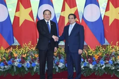 Thủ tướng Phạm Minh Chính và Thủ tướng Lào Sonexay Siphandone. (Ảnh: Báo Nhân Dân)