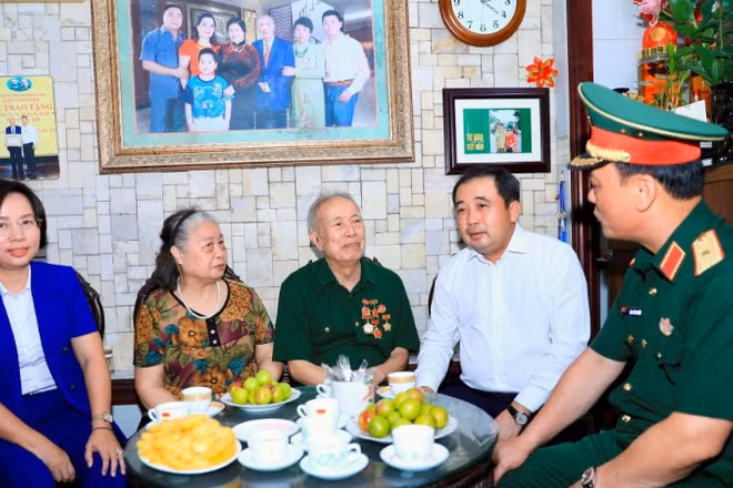 Bí thư Thành ủy Hà Nội Trần Đức Thắng trò chuyện cùng gia đình thương binh Vũ Đình Hồi.
