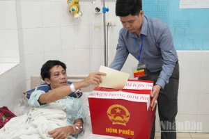 Hòm phiếu di động giúp người bệnh đang nằm điều trị trên giường bệnh vẫn thực hiện được quyền cử tri. 