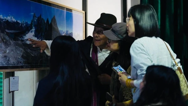 Nhiếp ảnh gia Sonam đang giới thiệu với khách tham quan về những bức ảnh về vùng núi tuyết Himalaya.