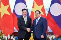 Thủ tướng Chính phủ Phạm Minh Chính và Tổng Bí thư, Chủ tịch nước Lào Thongloun Sisoulith. (Ảnh: TRẦN HẢI)