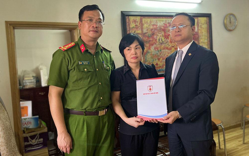 Đại diện Phòng Cảnh sát PCCC&CNCH và Hiệp hội PCCC và CNCH Việt Nam trao tặng sổ tiết kiệm cho gia đình Liệt sĩ Nguyễn Đình Phúc.