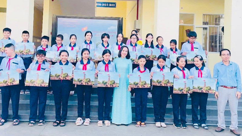 Nhà báo Trọng Duy, Trưởng Văn phòng đại diện Báo Nhân Dân tại Bạc Liêu và cô Trần Kim Thi, Bí thư Chi bộ, Hiệu trưởng Trường trung học cơ sở Lê Thị Cẩm Lệ (thành phố Bạc Liêu) trao tặng phụ san đặc biệt Cột cờ Hà Nội cho các em học sinh.