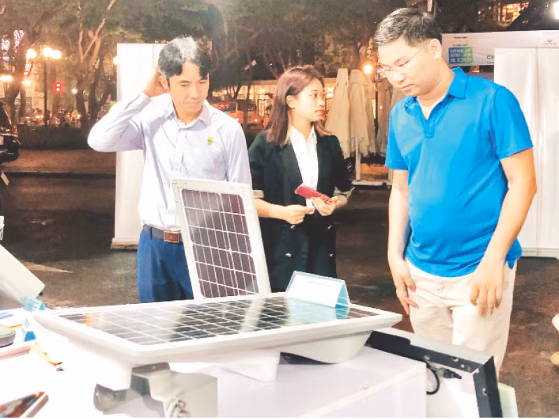Người tiêu dùng Hà Nội tìm hiểu về sản phẩm tấm pin năng lượng mặt trời.