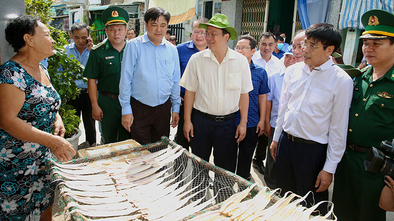 Phó Bí thư Thành ủy Thành phố Hồ Chí Minh Nguyễn Hồ Hải (áo trắng đội mũ) trò chuyện cùng người dân trên xã đảo Thạnh An, huyện Cần Giờ. (Ảnh: HOÀNG TRIỀU)