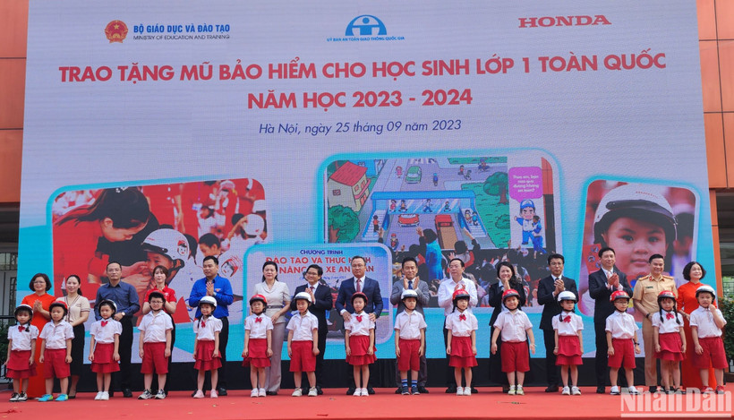 Đại diện Ủy ban An toàn giao thông Quốc gia, Bộ Giáo dục và Đào tạo, Công ty Honda Việt Nam trao tặng mũ bảo hiểm cho học sinh Trường tiểu học Phú Đô, Hà Nội, tháng 9/2023. (Ảnh: nhandan.vn)