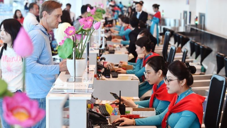 Quầy làm thủ tục tại sân bay rộn ràng sắc đỏ sao vàng, hành khách nhận thẻ lên tàu phiên bản đặc biệt in biểu tượng 2/9. 1-quay-lam-thu-tuc-tai-san-bay-ron-rang-sac-do-sao-vang-hanh-khach-nhan-the-len-tau-phien-ban-dac-biet-in-bieu-tuong-2-9-47.jpg