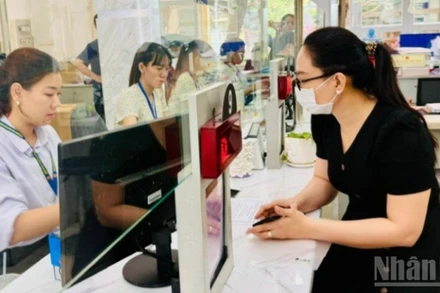 Cán bộ, công chức Thành phố Hồ Chí Minh giải quyết thủ tục hành chính cho người dân. (Ảnh: VƯƠNG LÊ)