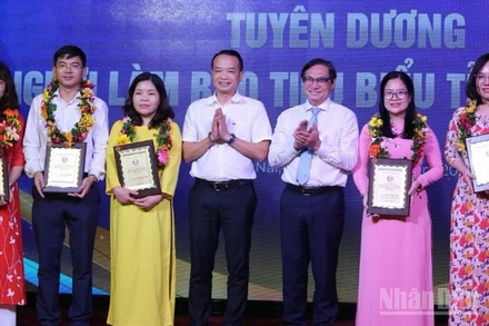 Phó Chủ tịch Ủy ban nhân dân tỉnh Đồng Nai Nguyễn Sơn Hùng và Phó Vụ trưởng, Phó trưởng Cơ quan đại diện Báo Nhân Dân tại khu vực miền nam An Văn Quang trao tặng danh hiệu nhà báo tiêu biểu tỉnh Đồng Nai.