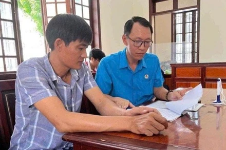 Đại diện Trung tâm Tư vấn pháp luật Công đoàn, Liên đoàn Lao động tỉnh Đồng Nai hỗ trợ pháp lý cho người lao động. (Ảnh HÀ ANH CHIẾN)
