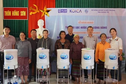 Đồng bào Bru-Vân Kiều ở xã Trường Sơn nhận thiết bị lọc nước để phục vụ cuộc sống gia đình.