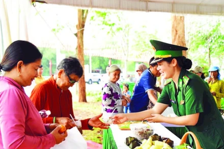 Cán bộ Đồn Biên phòng quốc tế Hoa Lư trao các suất ăn 0 đồng cho nhân dân xã Lộc Thạnh tham gia “Ngày hội Biên phòng toàn dân” được tổ chức ngày 3/3 vừa qua.