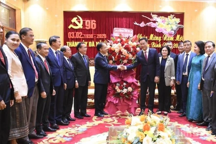 Đồng chí Daovong Phonekeo tặng lẵng hoa chúc mừng đồng chí Lê Ngọc Quang, Ủy viên Trung ương Đảng, Bí thư Thành ủy Đà Nẵng. (Ảnh: ANH ĐÀO)