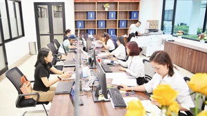 Cán bộ, công chức Điểm phục vụ hành chính công phường Đống Đa (thành phố Hà Nội) hướng dẫn người dân làm thủ tục hành chính. (Ảnh: THẾ ĐẠI)