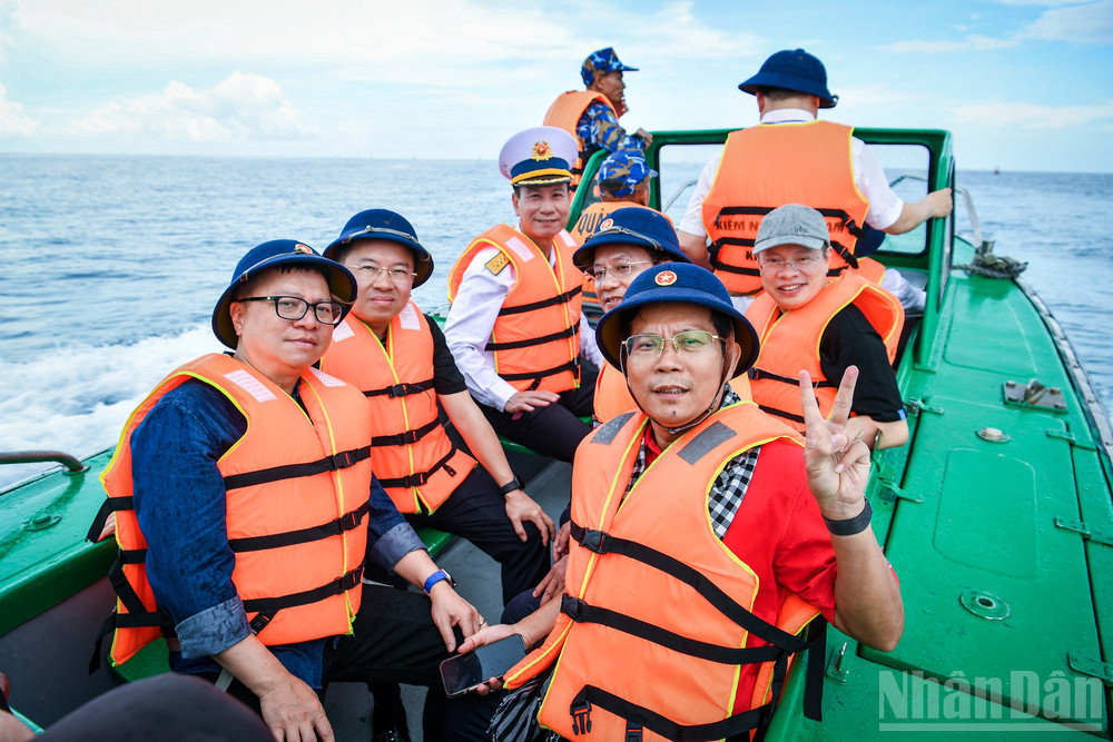 Nhà báo Lê Quốc Minh, Ủy viên Trung ương Đảng, Tổng Biên tập Báo Nhân Dân, Phó trưởng Ban Tuyên giáo và Dân vận Trung ương, Chủ tịch Hội Nhà báo Việt Nam cùng đồng hành với các cơ quan báo chí trên chiếc canô tiến vào đảo. ndo_br_40a.jpg