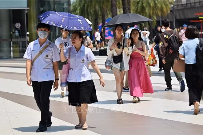 Người dân che ô tránh nắng nóng tại Bangkok, Thái Lan. (Ảnh tư liệu: TTXVN)