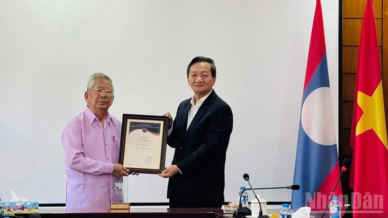 Đại sứ Nguyễn Minh Tâm trao Giải thưởng toàn quốc về Thông tin đối ngoại lần thứ XI-năm 2025 cho Nghệ sĩ quốc gia Lào, nhạc sĩ Duoangmixay Likaya. (Ảnh: DUY TOÀN)