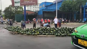Rất đông người dân hỗ trợ tài xế thu gom dưa hấu. (Ảnh cắt từ video clip)