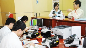 Tỷ giá chịu tác động mạnh mẽ do nhu cầu nhập khẩu hàng hóa của các doanh nghiệp. Ảnh: NAM HẢI