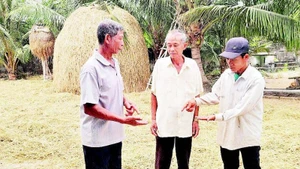 Phạm Hào (ngoài cùng bên trái) vận động người dân trong thôn xây dựng nông thôn mới.