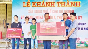 Khánh thành nhà Đại đoàn kết và tặng ti-vi cho gia đình bà Đặng Thị Hà ở Khối 5, thị trấn Tân Kỳ. (Ảnh Thanh Nhàn) 