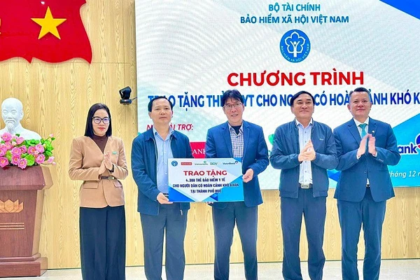 Phó Giám đốc Chu Mạnh Sinh, đại diện Bảo hiểm xã hội Việt Nam và các nhà tài trợ trao biểu trưng tặng hơn 4.000 thẻ bảo hiểm y tế cho bà con có hoàn cảnh khó khăn ở thành phố Huế. (Ảnh VSS)