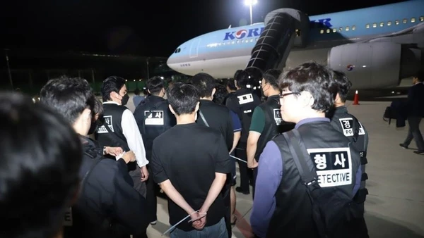 Các công dân nước ngoài liên quan hoạt động lừa đảo sử dụng công nghệ được bàn giao tại sân bay quốc tế ở thủ đô Phnom Penh, Vương quốc Campuchia, tối 17/10/2025. (Ảnh: AKP/TTXVN phát)