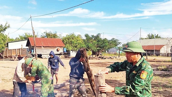 Cán bộ, chiến sĩ Đồn Biên phòng Ia Mơ giúp đỡ gia đình anh Rơ Mah Choan. Ảnh: ĐVCC