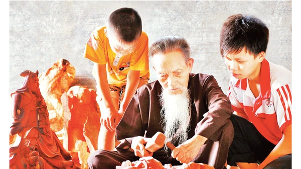 Nghệ nhân làng nghề gỗ mỹ nghệ Thiết Úng truyền nghề cho con, cháu. Ảnh: Đỗ Phong 