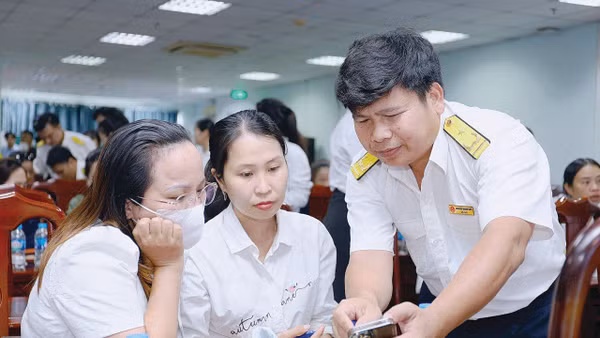 Cán bộ Thuế Thành phố Hồ Chí Minh hỗ trợ, hướng dẫn hộ kinh doanh, cá nhân kinh doanh thực hiện kê khai thuế điện tử. Nguồn: Cục Thuế 