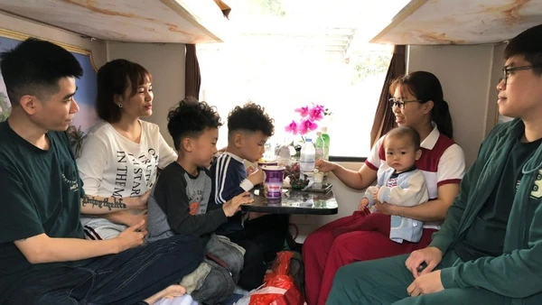 Gia đình chị Nguyễn Minh Thu, Nguyễn Thu Trang quây quần trong khoang tàu.