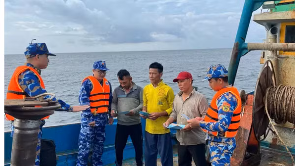 Cán bộ, chiến sĩ Bộ Tư lệnh Vùng Cảnh sát biển 3 phối hợp tuyên truyền về IUU cho ngư dân đang hành nghề trên vùng biển phía nam. Ảnh: MẠNH THẮNG