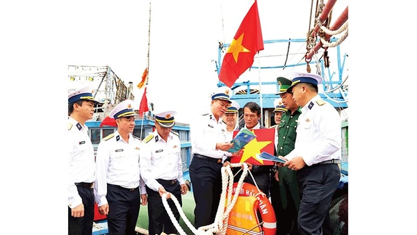 Chuẩn Đô đốc Nguyễn Đăng Tiến, Bí thư Đảng ủy, Chính ủy Vùng 3 Hải quân (người thứ tư từ trái qua) tuyên truyền biển đảo cho ngư dân.