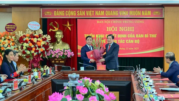 Đồng chí Phan Đình Trạc, Ủy viên Bộ Chính trị, Bí thư Trung ương Đảng, Trưởng Ban Nội chính Trung ương trao Quyết định và tặng hoa chúc mừng đồng chí Nguyễn Xuân Trường. (Ảnh: BẢO LONG)