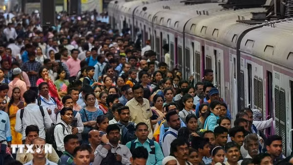 Người dân chen lấn chờ lên tàu hỏa tại nhà ga ở Mumbai, Ấn Độ. (Ảnh: AFP/TTXVN)