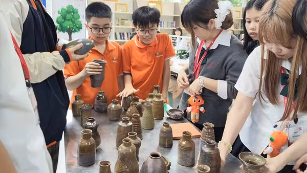 Các em nhỏ tham gia trải nghiệm làm nghề thủ công truyền thống. 