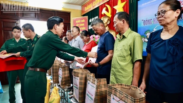 Thượng tá Nguyễn Văn Lập, Chủ nhiệm chính trị Bộ đội Biên phòng thành phố Hải Phòng trao quà và tặng cờ Tổ quốc cho các hộ dân trên đảo.