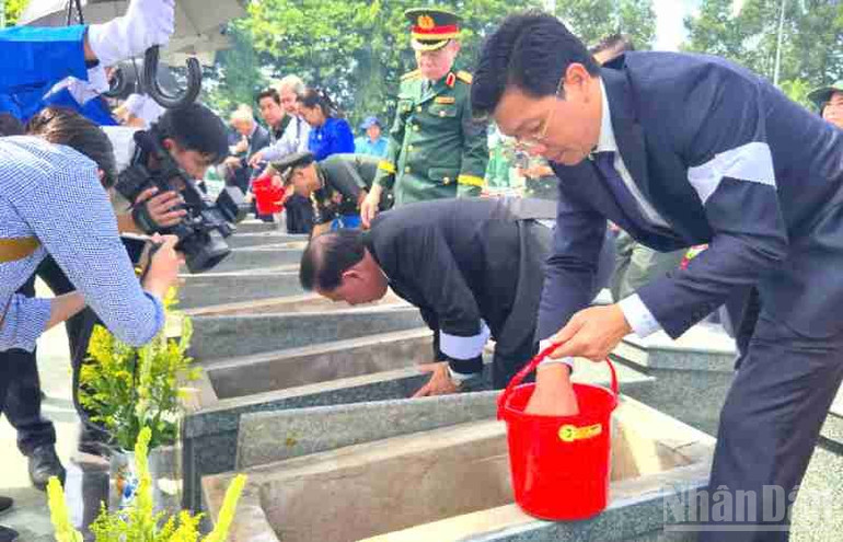 Lãnh đạo tỉnh Tây Ninh thực hiện nghi thức để đất vào mộ các Anh hùng liệt sĩ. ndo_br_z6816293070798-4c4a0f2804e694b5db064fc6b3af037c.jpg
